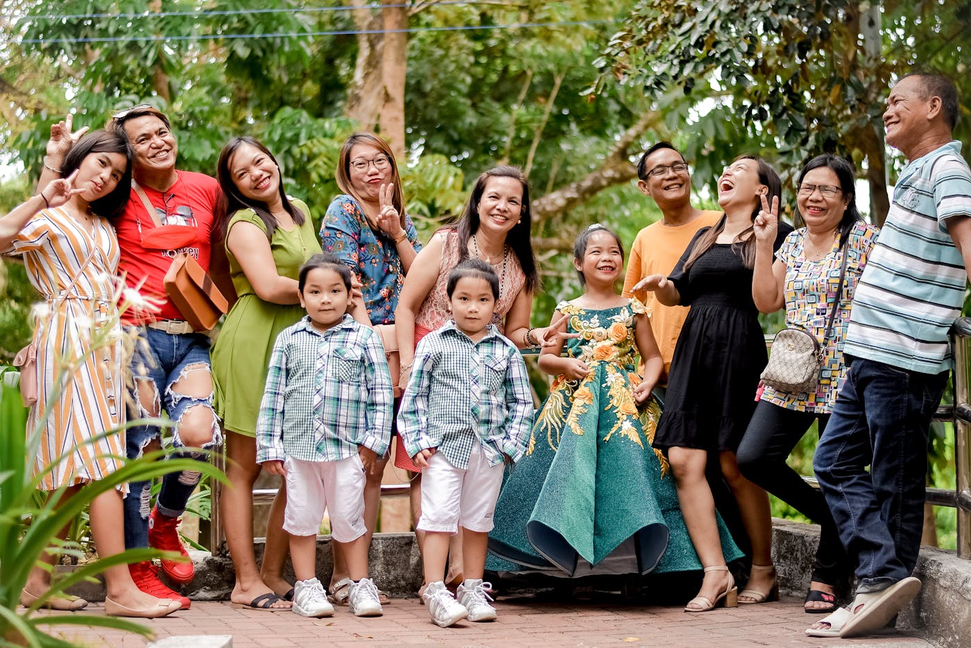 Multi-generational Indian family smiling together outdoors in daylight